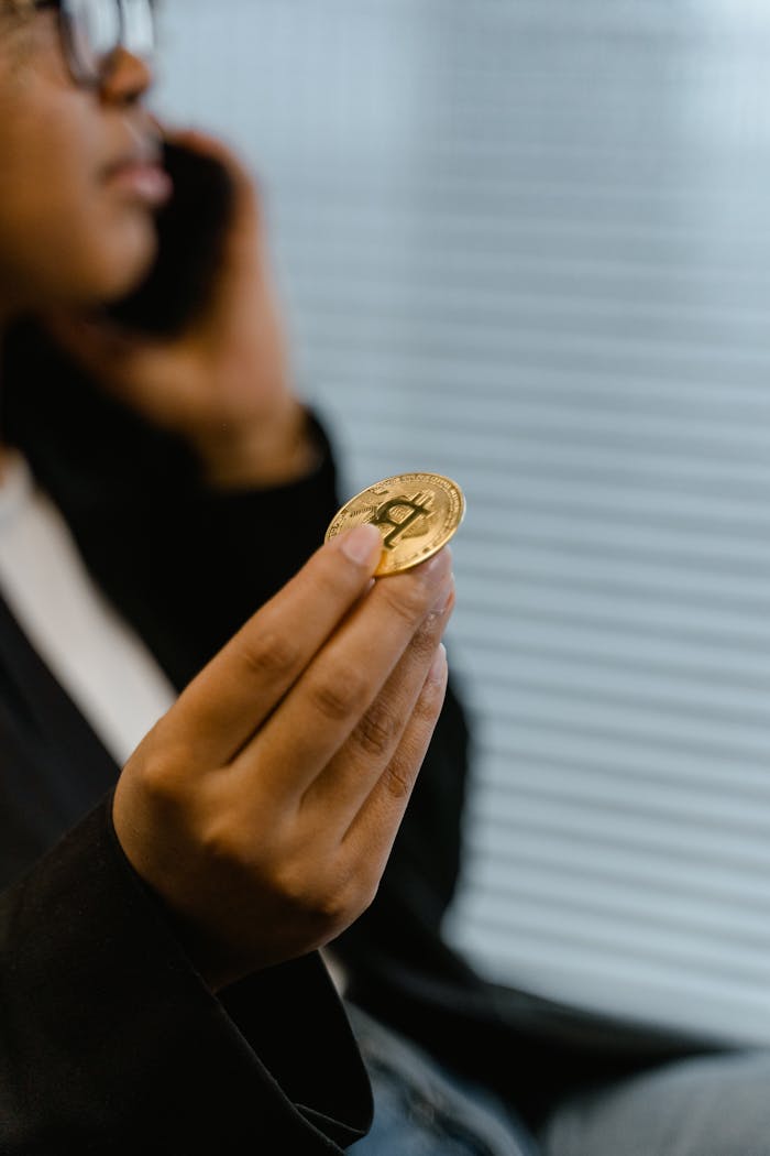 Portrait of a woman holding a Bitcoin, symbolizing digital finance and cryptocurrency trends.